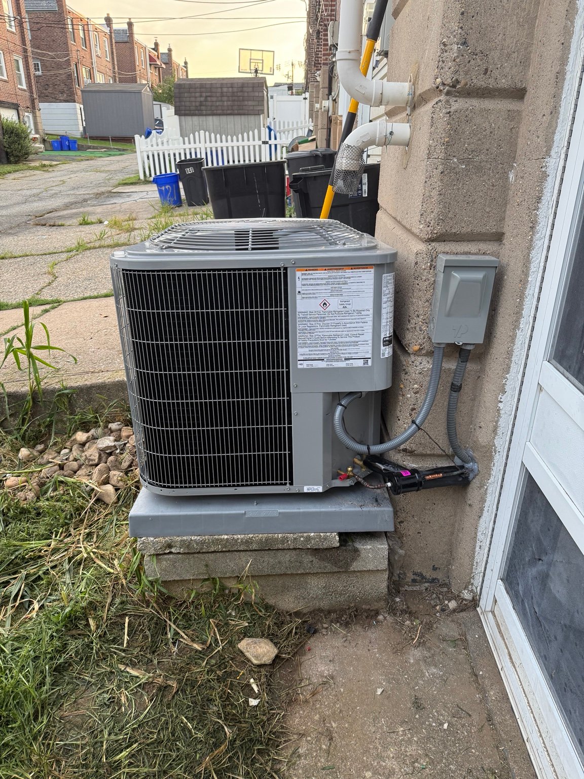 Outdoor condenser with electrical disconnect and refrigerant-line connections by TrueField Home Services in Delaware County, PA