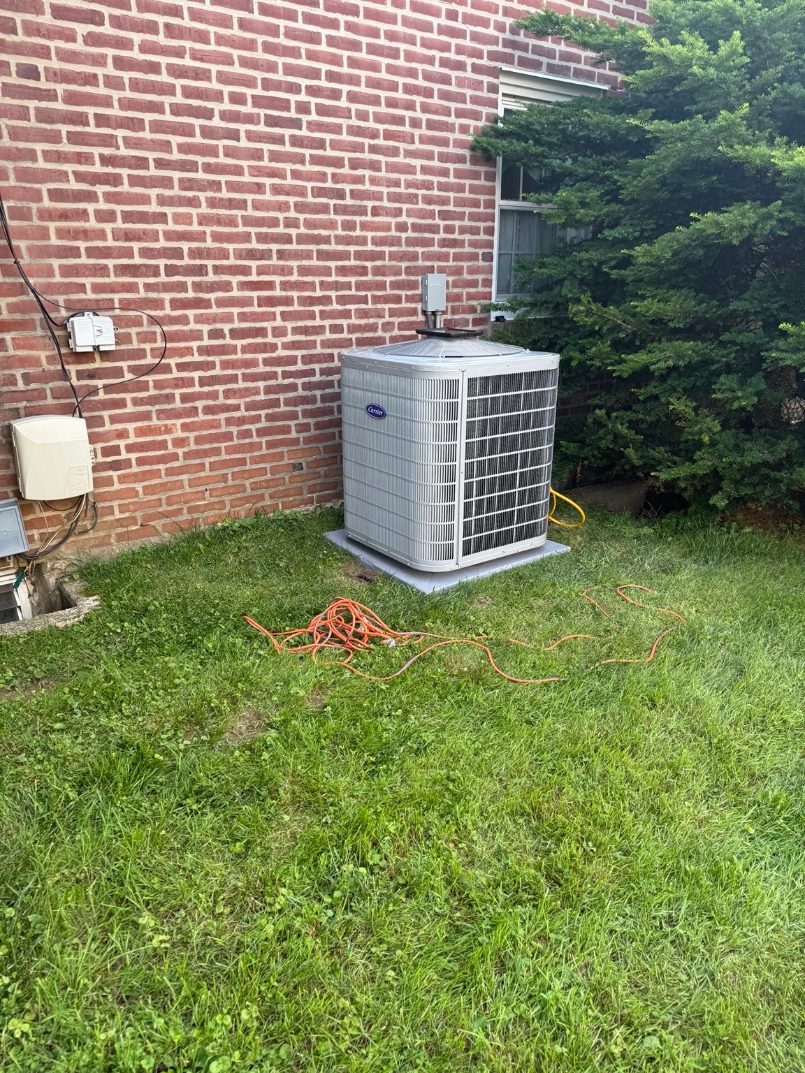 Carrier outdoor condenser installed beside a Delaware County home by TrueField Home Services in Delaware County, PA