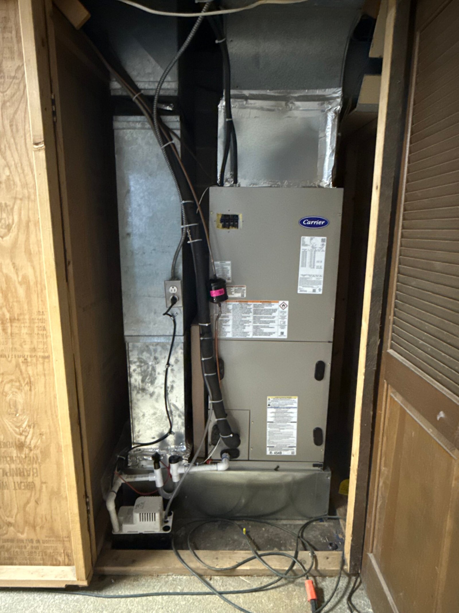 Carrier heat-pump air handler installed in a compact mechanical space by TrueField Home Services in Delaware County, PA