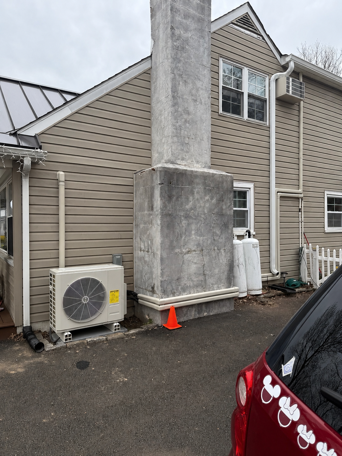 Outdoor ductless mini-split condenser installed beside a Delaware County home by TrueField Home Services